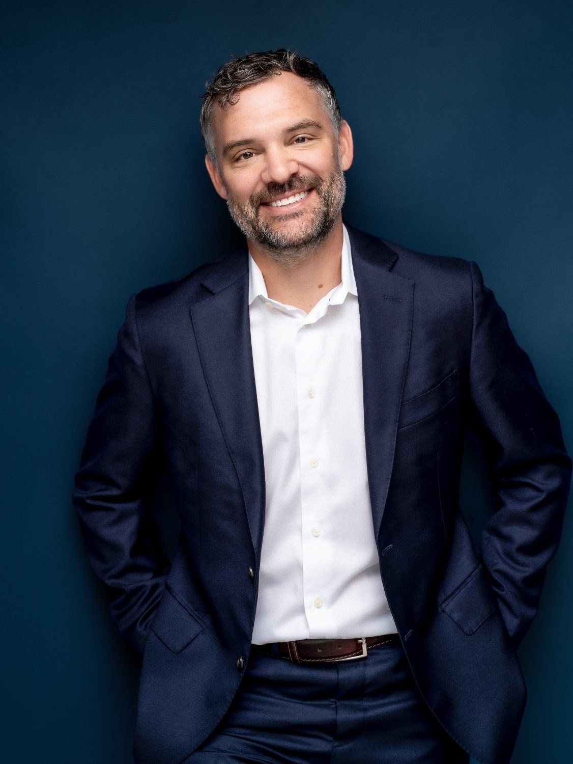 Business portrait from a branding session, seated at a desk