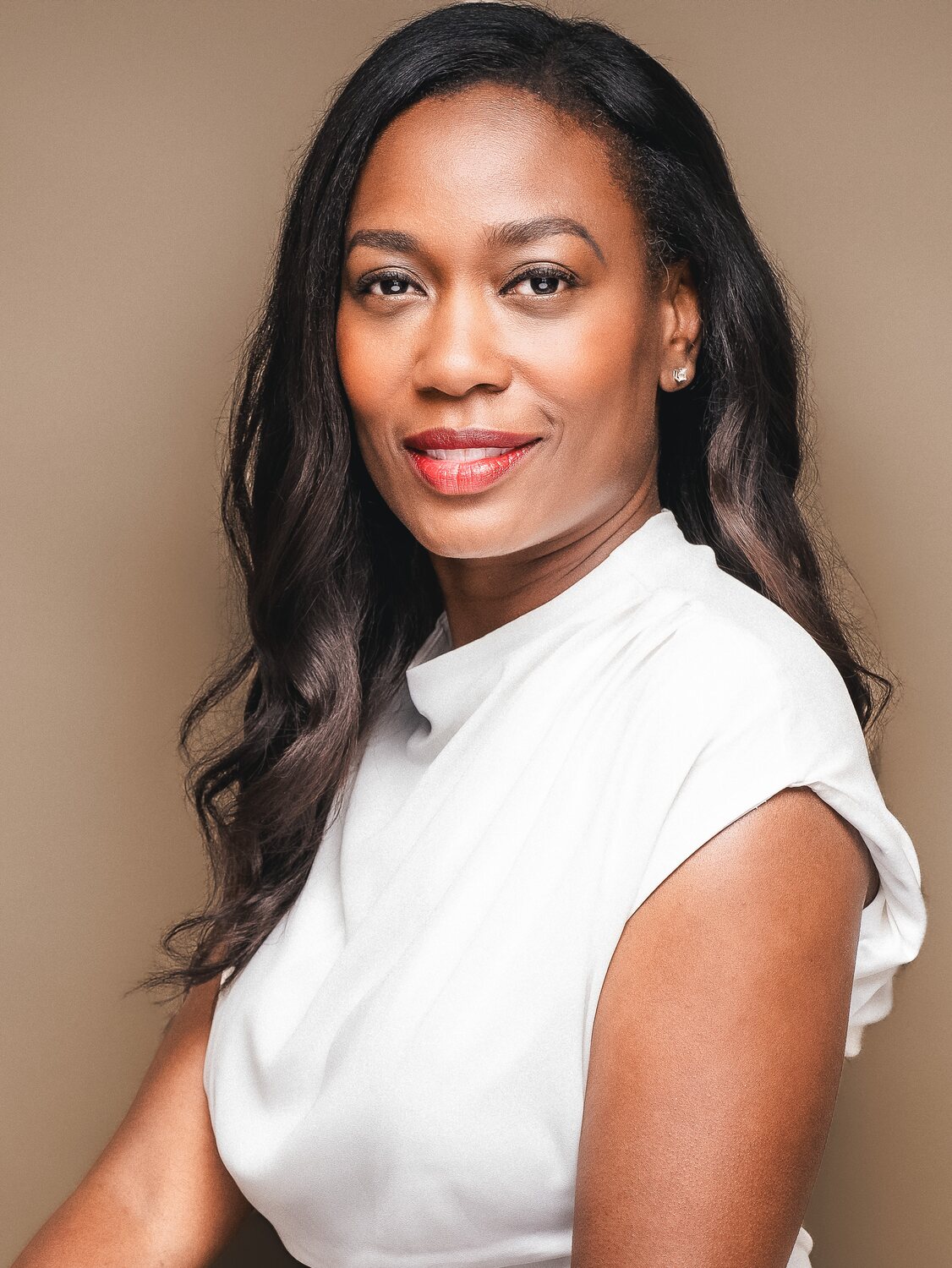 Professional headshot showing a simple solid-color wardrobe choice