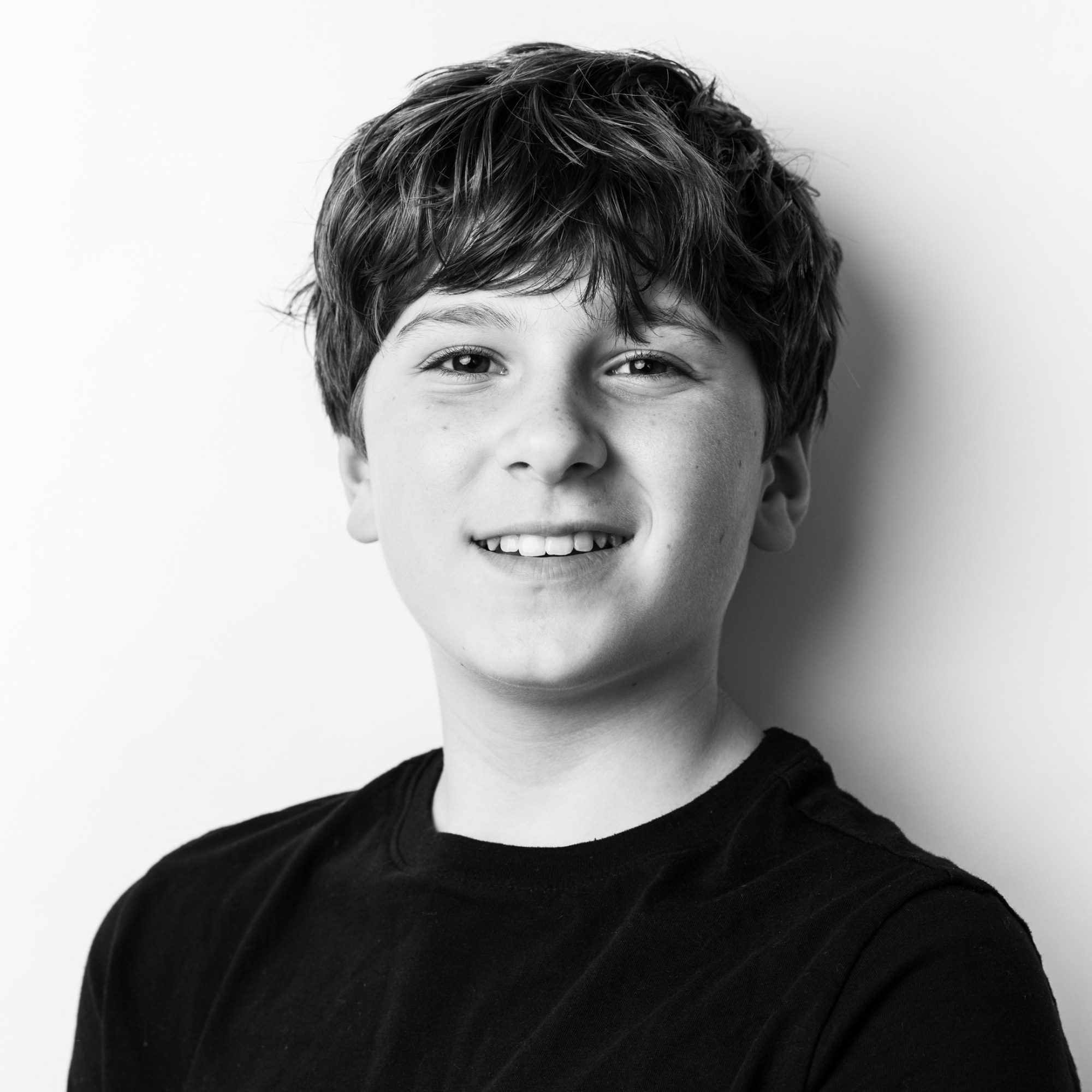 Studio portrait of a young boy on a dark background